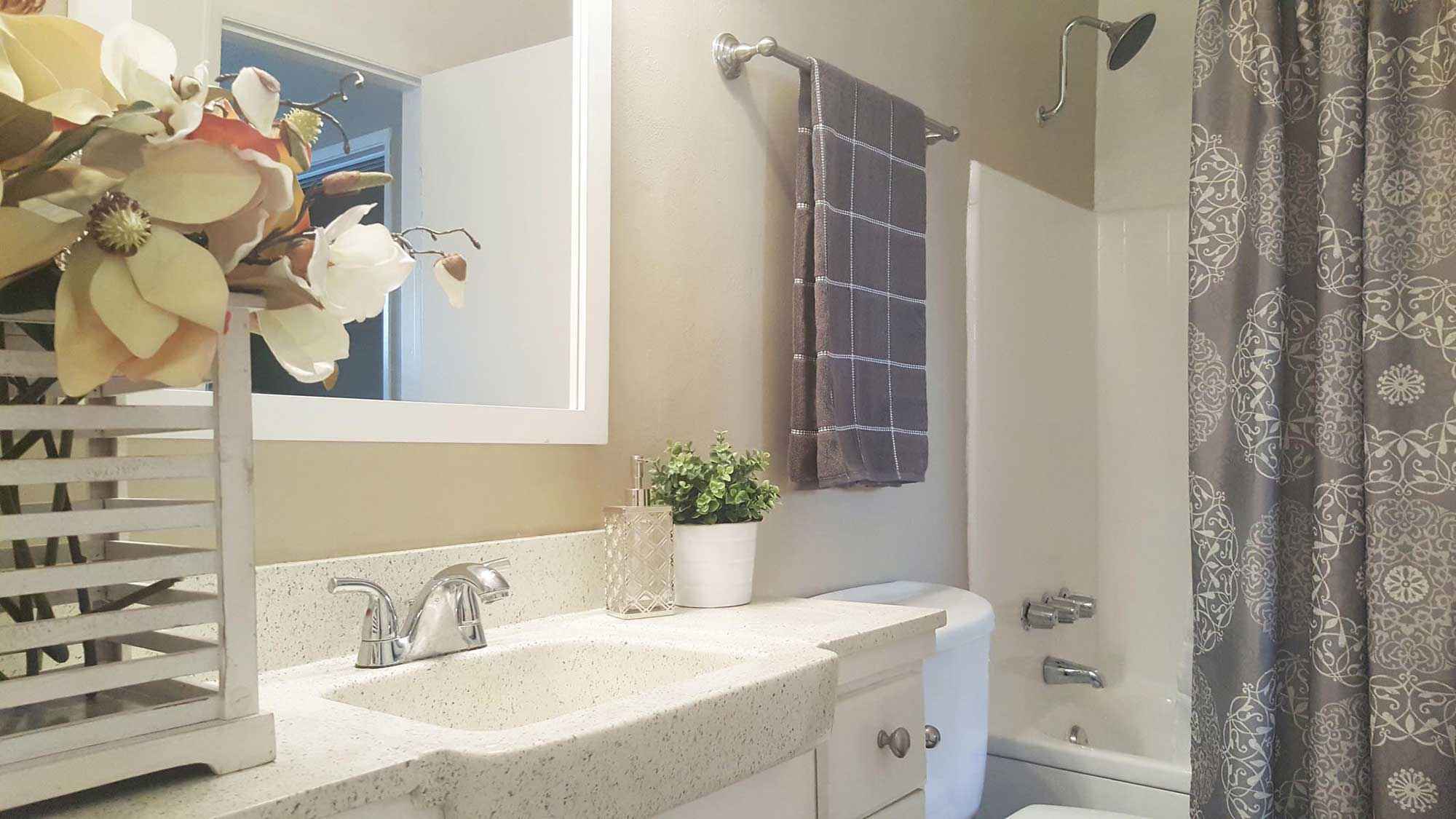 decorated bathroom sink shower at Terraces